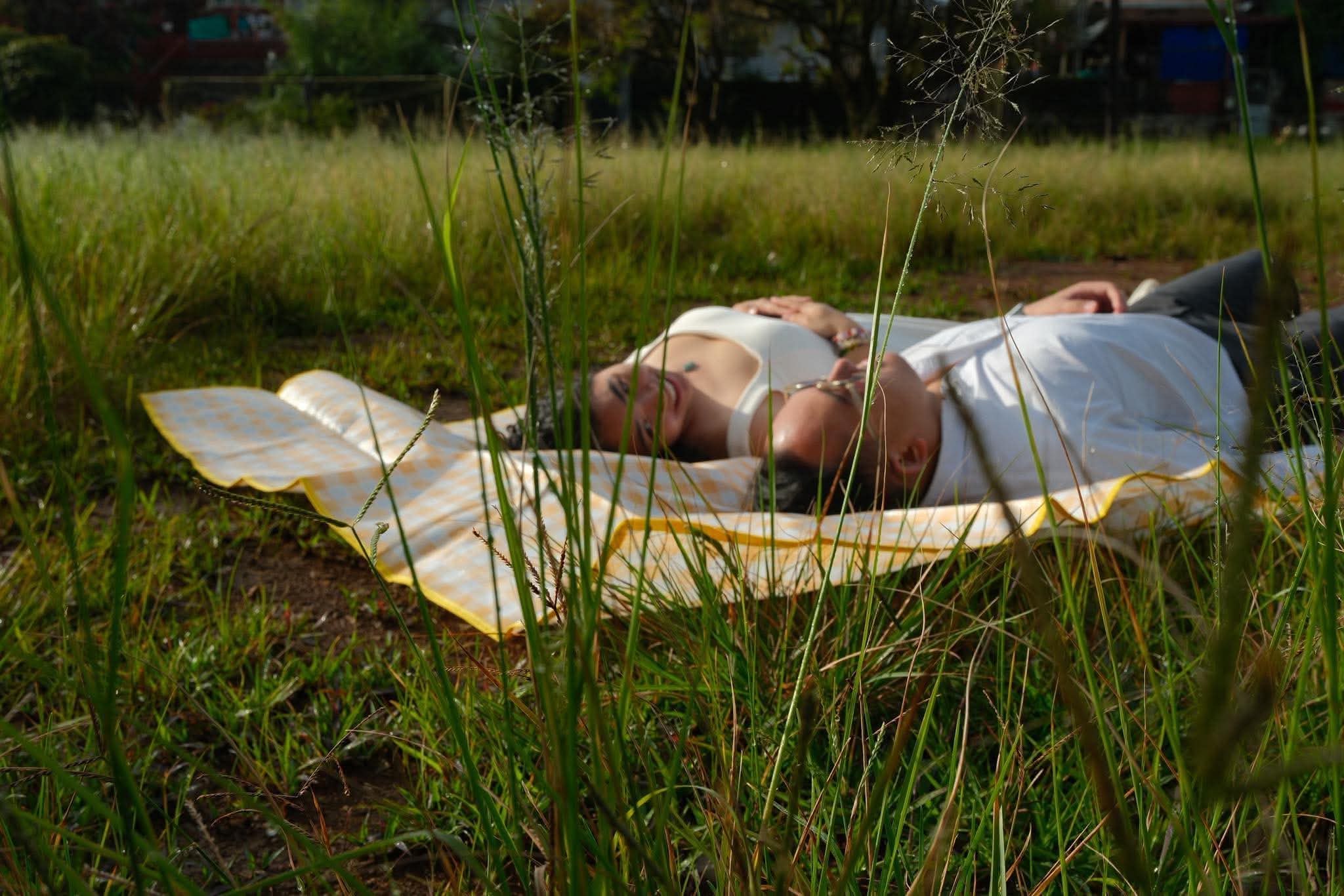 Syd and Franz on a blanket in an open field